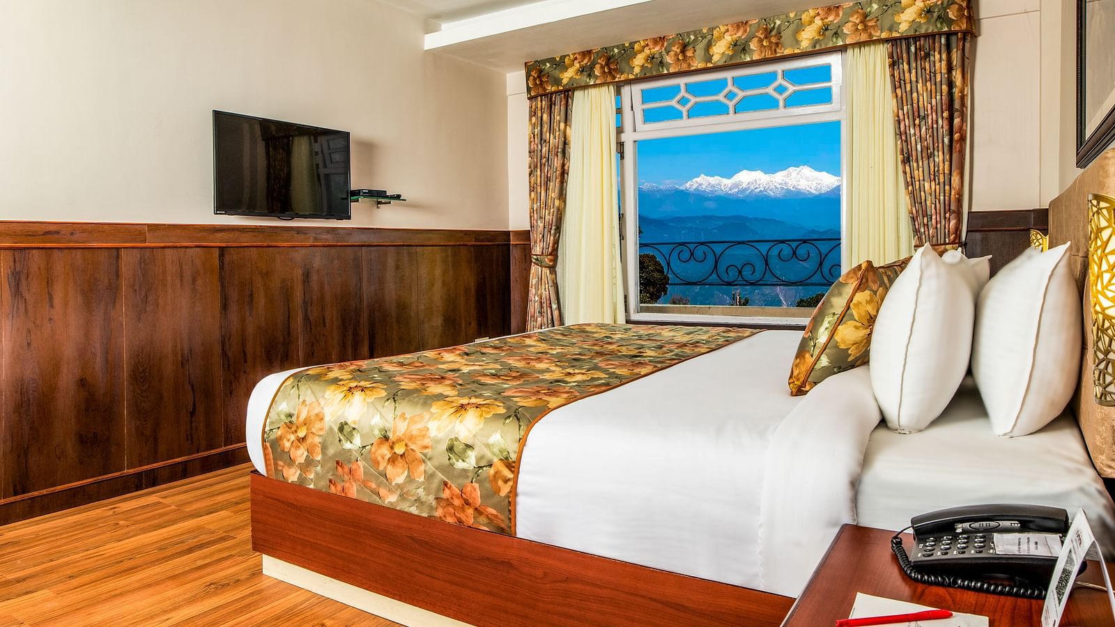 A side view of a bed in a room that has a glass window | Summit Oakden Resort & Spa, Mall Road
