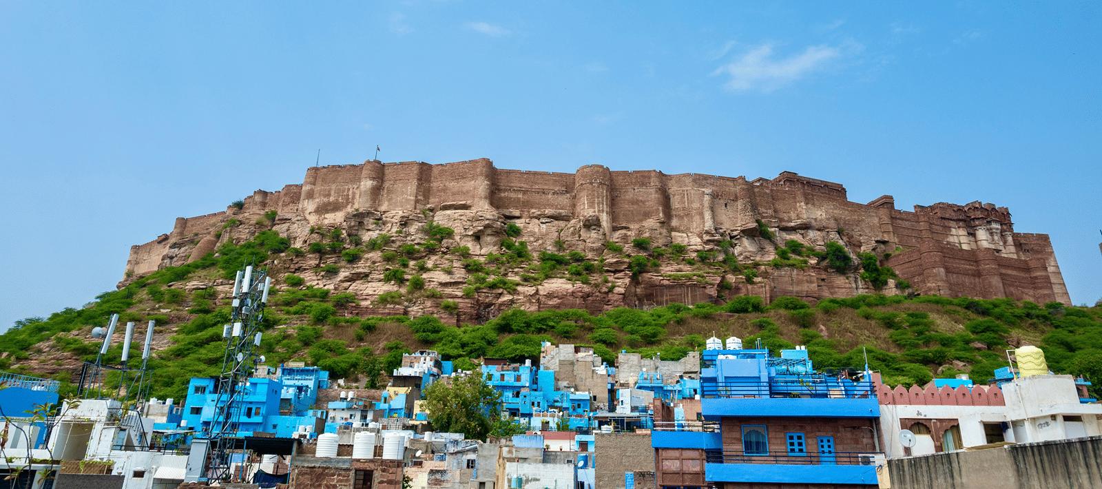 an imposing shot of Mehrangarh Fort looming over the city of Jodhpur