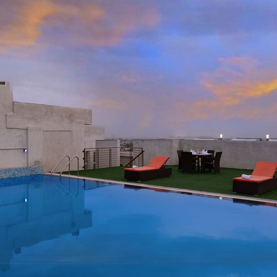 Rooftop Swimming pool with lounge chairs and a seating arrangement