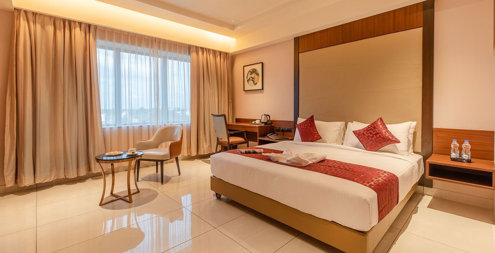 An image of a room with a bed, a chair, and a table at M Pro Palace.