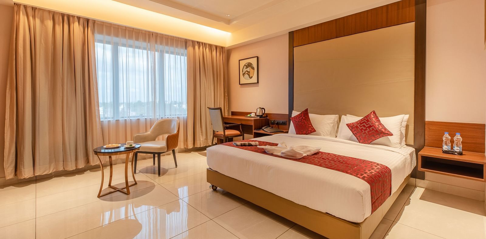 An image of a room with a bed, a chair, and a table at M Pro Palace.