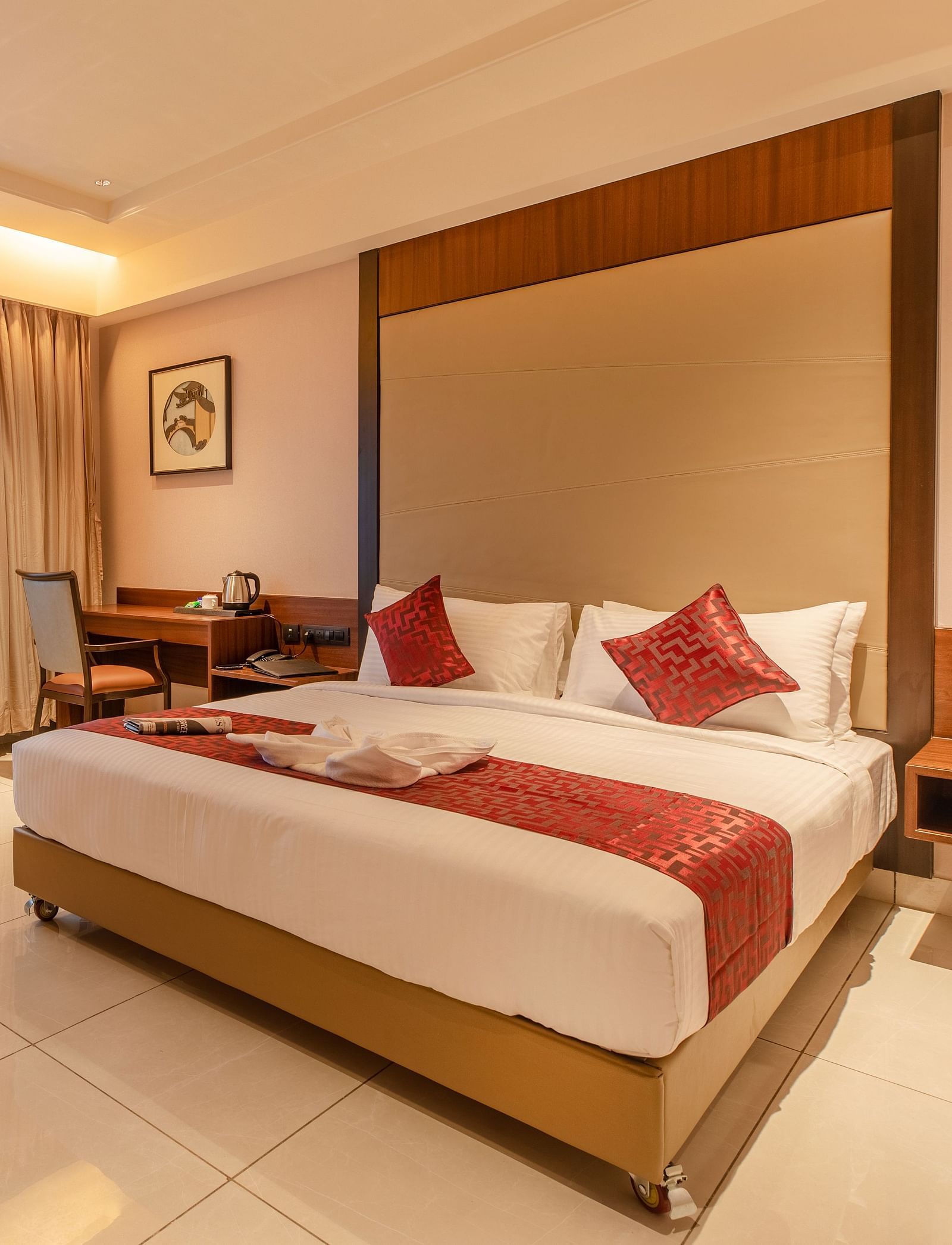An image of a room with a bed, a chair, and a table at M Pro Palace.