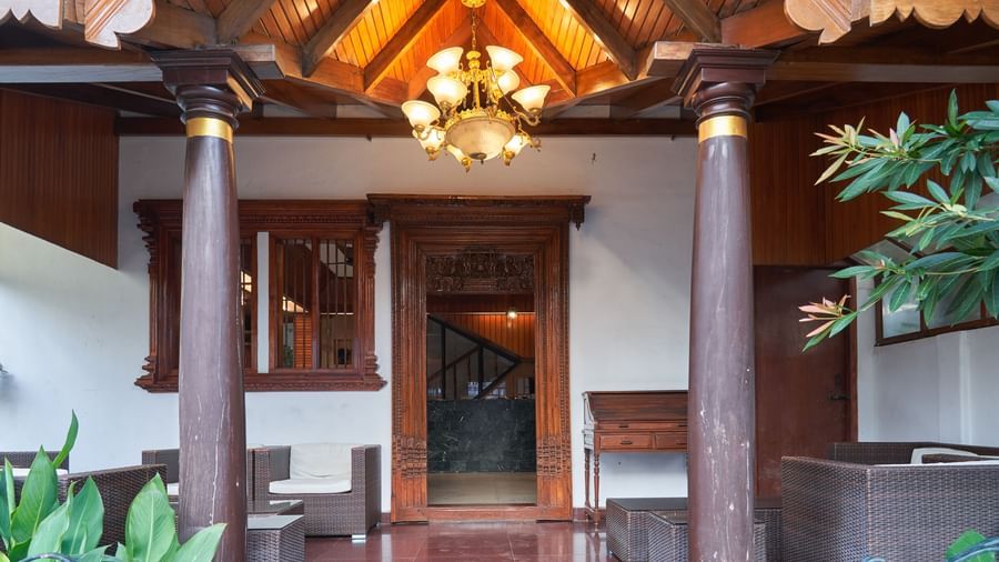 The welcoming lobby or entrance area of Hotel Mamallaa Heritage, featuring traditional wooden architecture, decorative elements, and warm lighting.