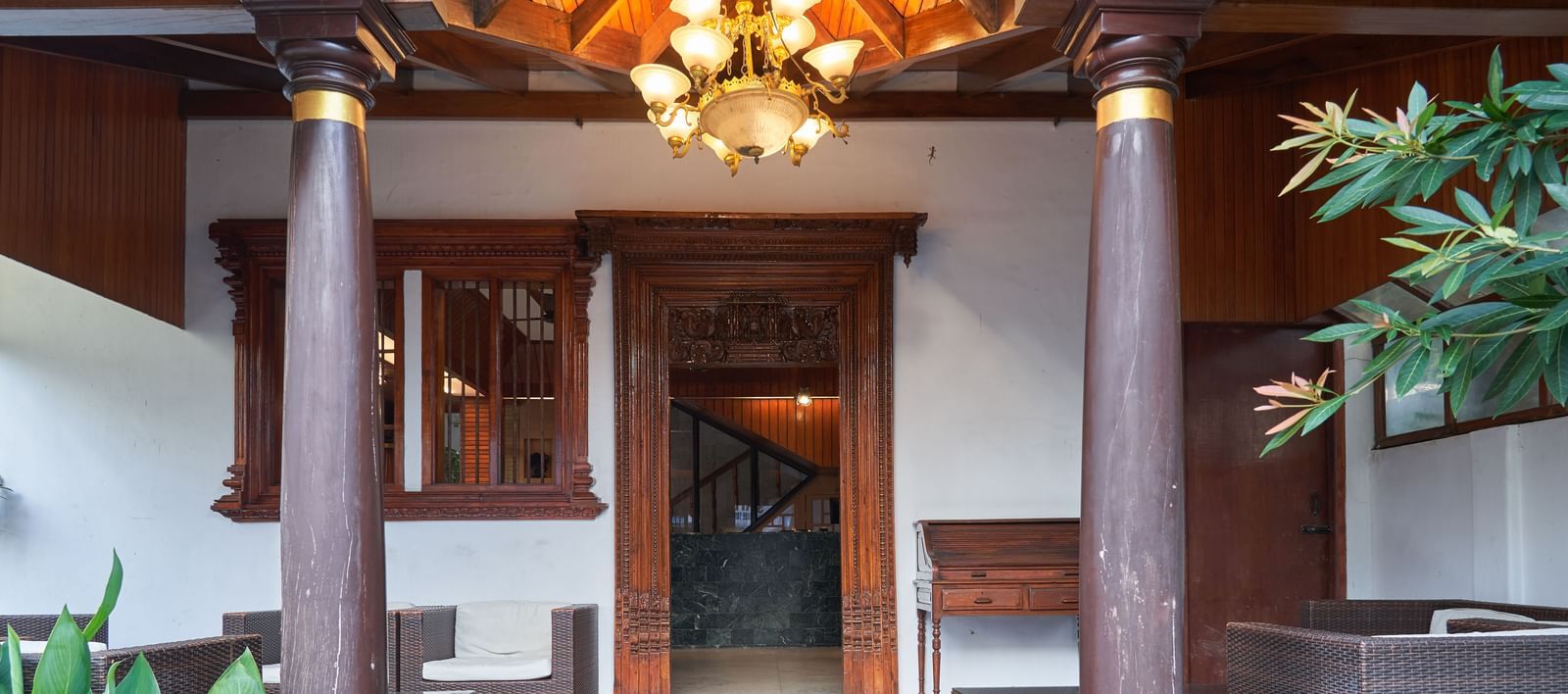 The welcoming lobby or entrance area of Hotel Mamallaa Heritage, featuring traditional wooden architecture, decorative elements, and warm lighting.