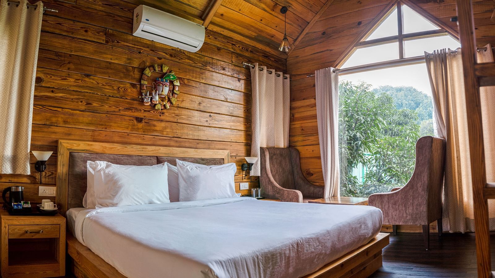A view of the large bed at Pinewood Cottage at the Sylvan Retreat, Dehradun.