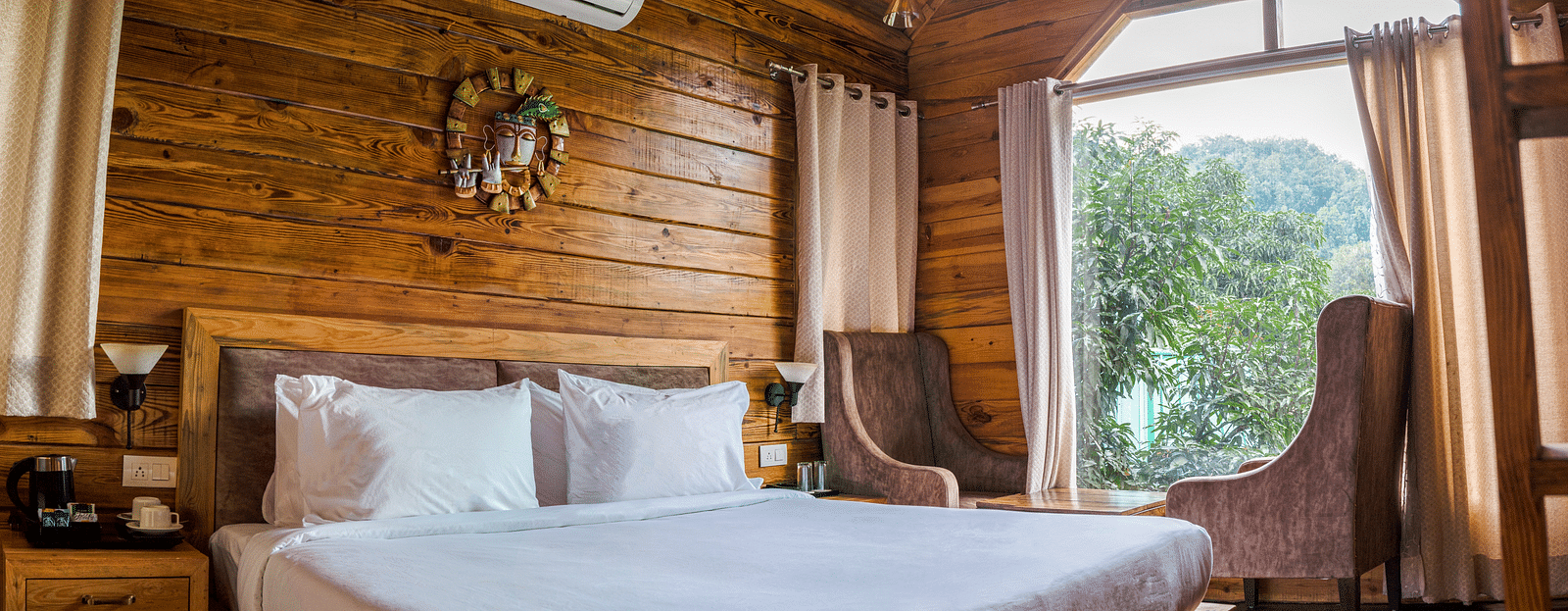 A view of the large bed at Pinewood Cottage at the Sylvan Retreat, Dehradun.