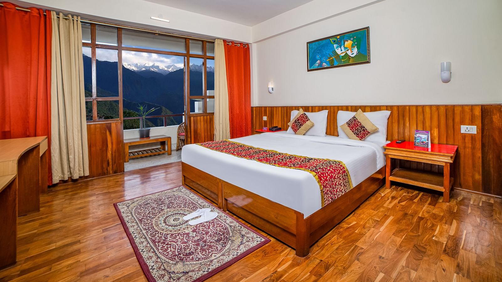 A comfortable room at Sumitel, Pelling, offering a cosy double bed and splendid views of the surrounding mountains.