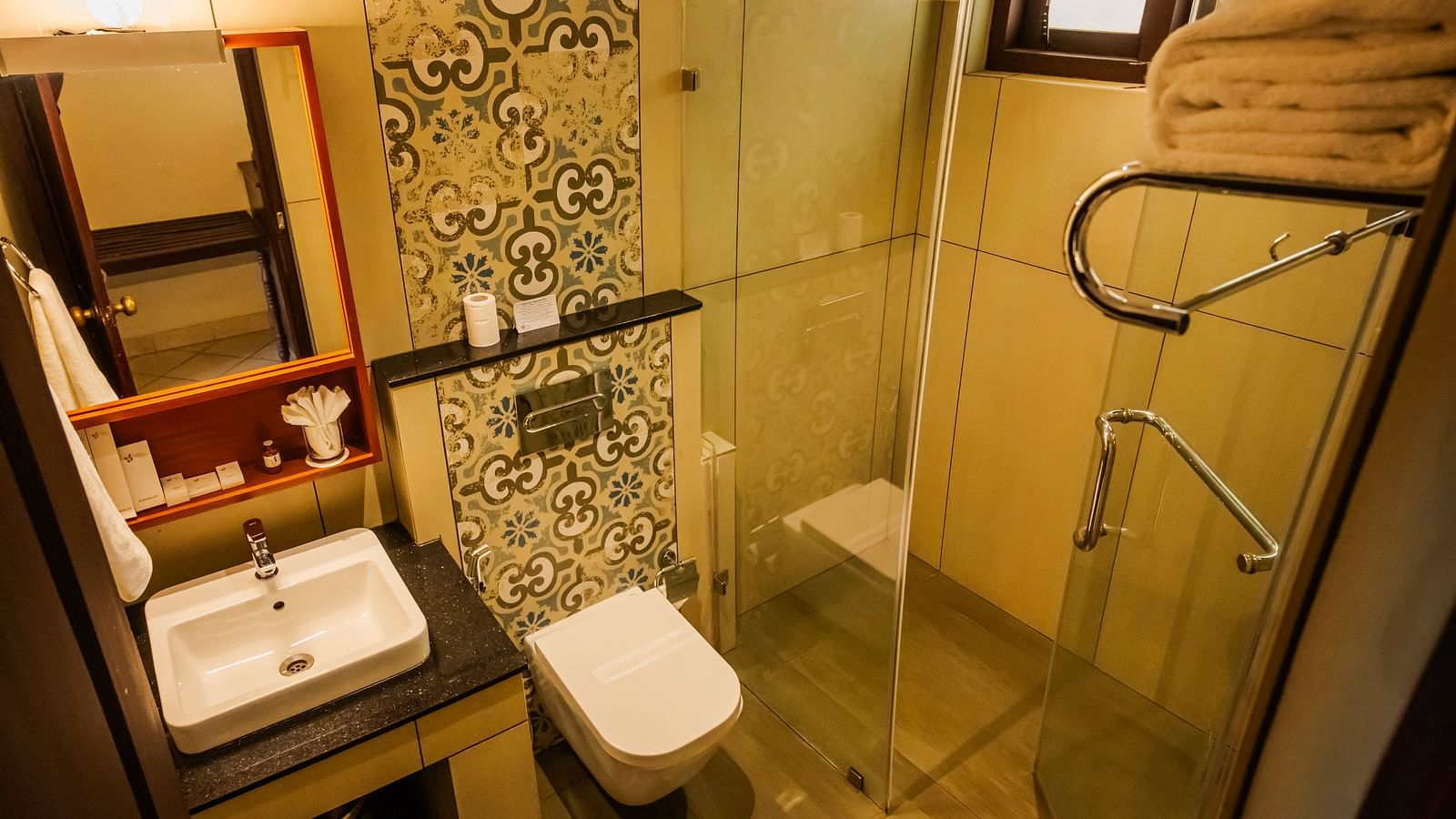 Modern bathroom with a sink, toilet, and shower at a resort.