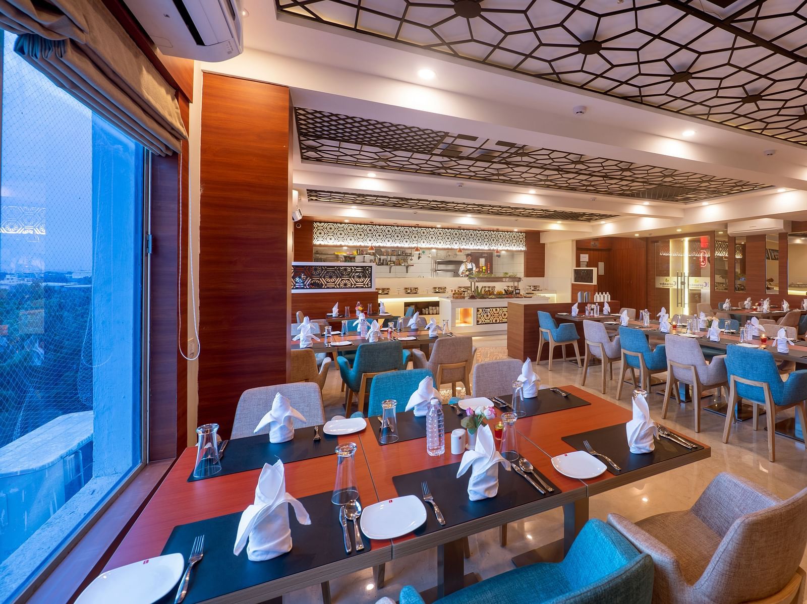 Dining area offering a variety of seating options and ambient lighting - Lords Eco Inn Shapar Rajkot