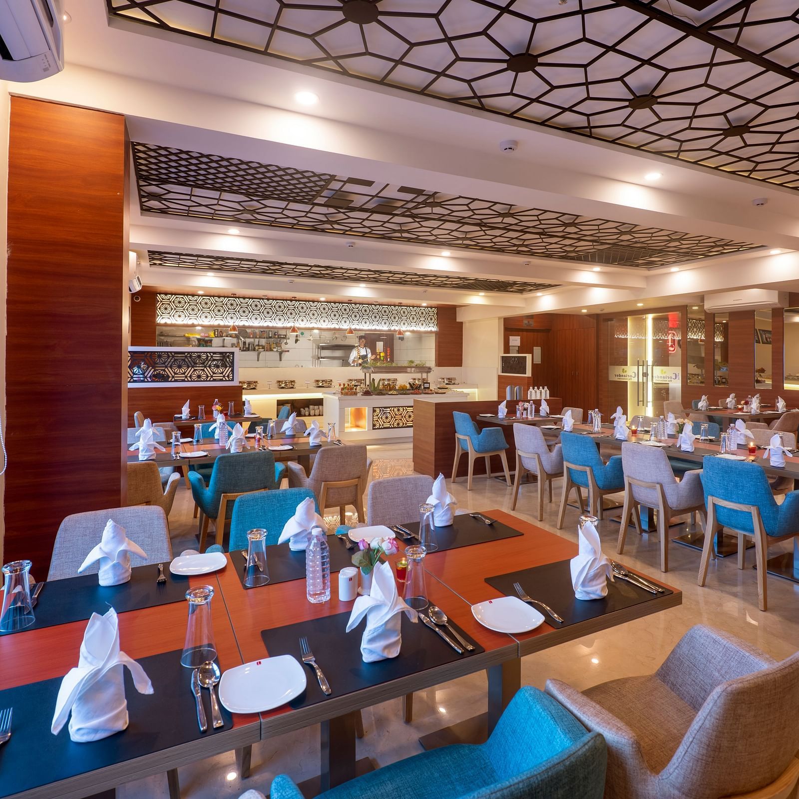 Warmly lit dining area of Lords Eco Inn Shapar Rajkot, featuring spacious seating and modern interiors