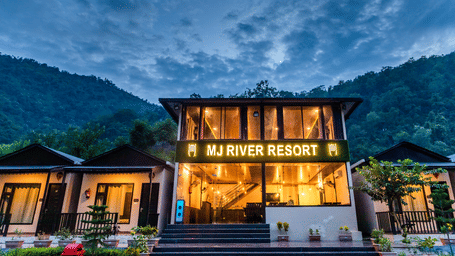 Facade view of DLS MJ River Resort, Rishikesh on a cloudy evening.