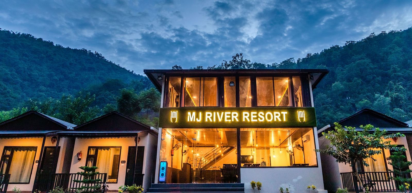 Facade view of DLS MJ River Resort, Rishikesh on a cloudy evening.