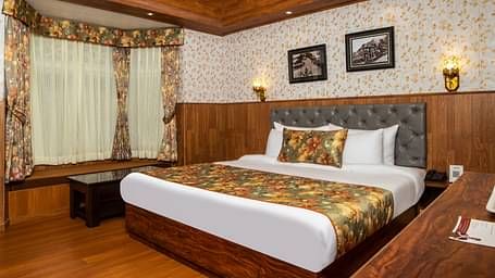 A bed in a room that has a glass window | Summit Oakden Resort & Spa, Mall Road