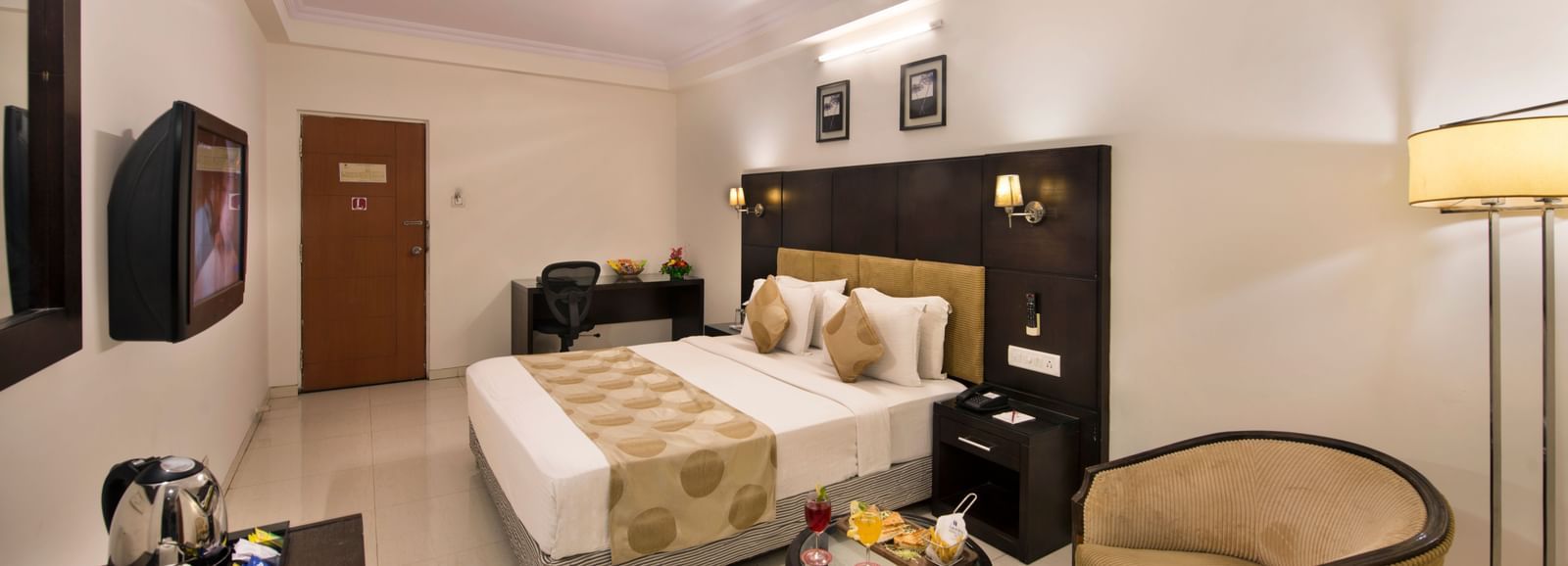 Modern guest room at Lords Eco Inn Dahej featuring a cosy double bed, stylish interiors, and workspace.