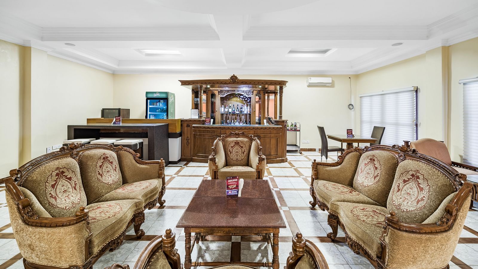 An image of the Amrutham Bar with seating arrangement with royal decoration and bright lit room - GReaT Trails River View Resort Thanjavur By GRT Hotels