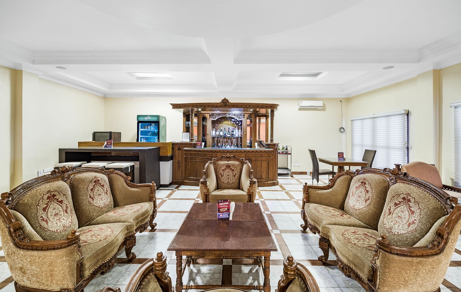 An image of the Amrutham Bar with seating arrangement with royal decoration and bright lit room - GReaT Trails River View Resort Thanjavur By GRT Hotels
