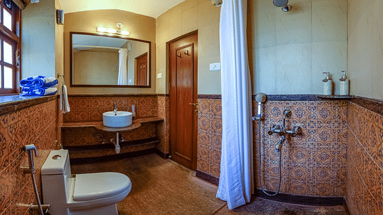 An overview of the bathroom at Cassis room in neemrana s three waters
