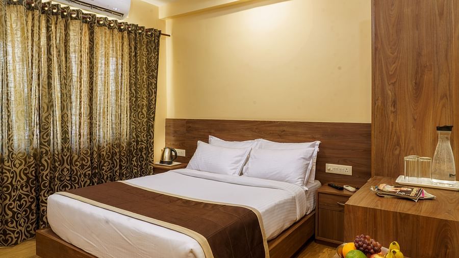 Standard room with bed and side table at Wyt Hotels, Rameswaram