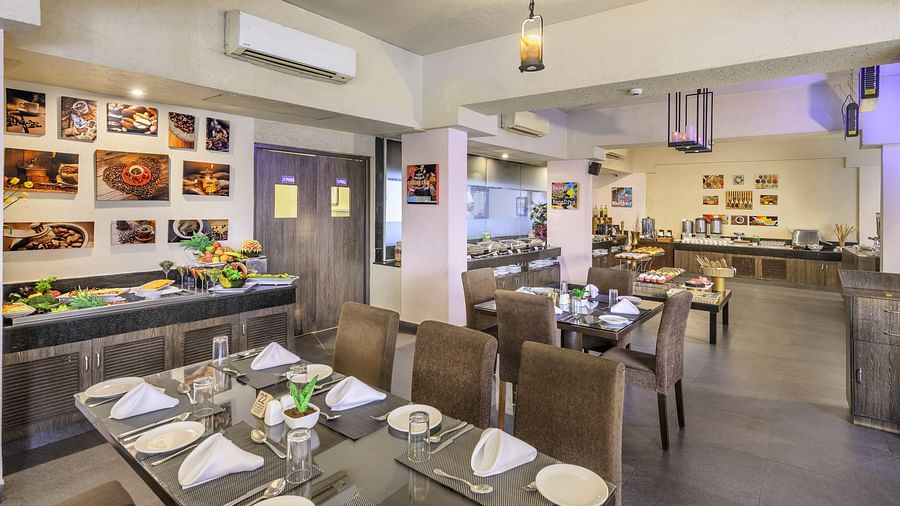 Restaurant interior at Golden Tulip, Candolim, Goa, featuring elegant seating arrangements and a casual, warm ambience.