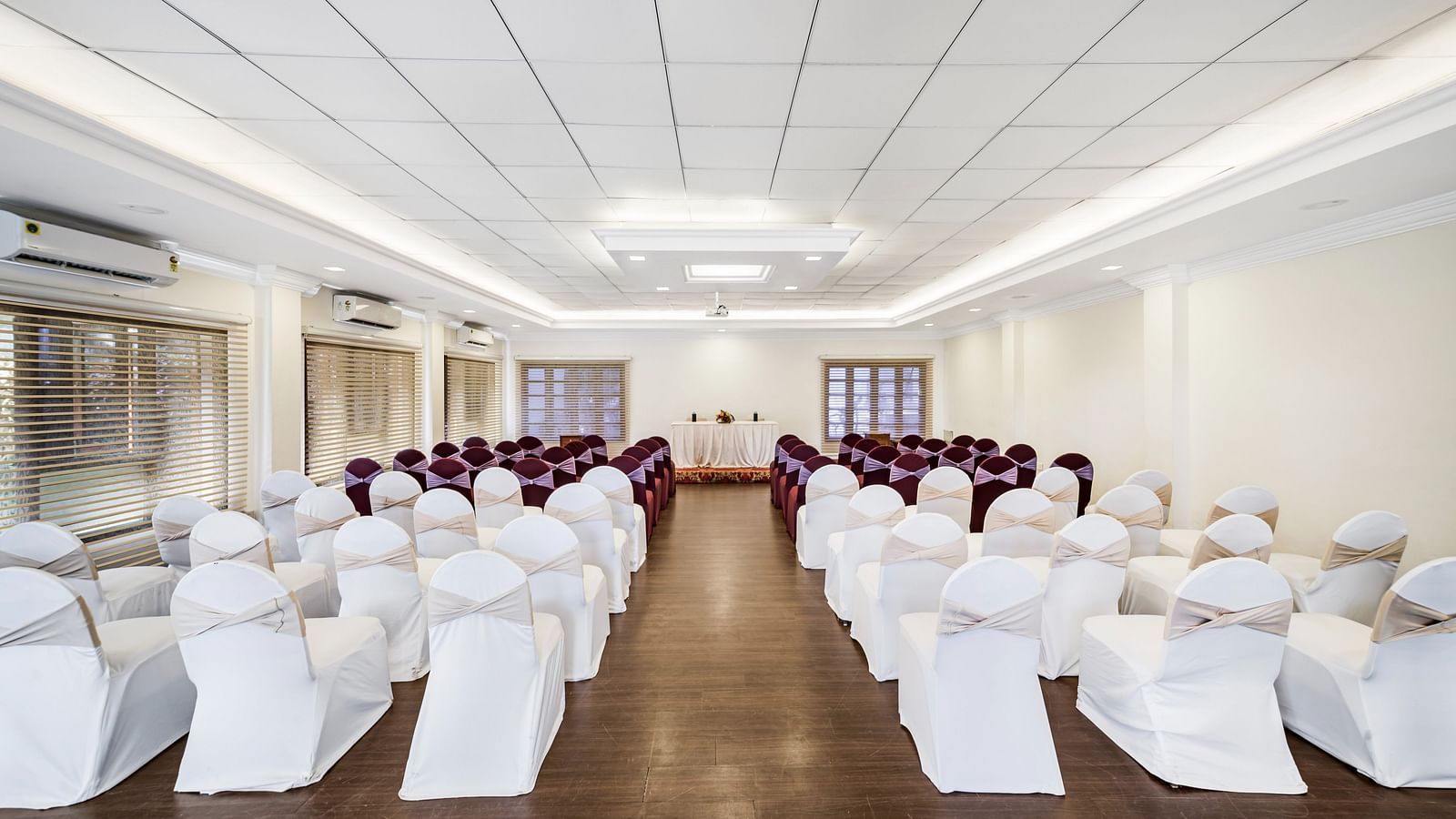 An image of a banquet hall with seating arrangement and bright lighting - GReaT Trails River View Resort Thanjavur By GRT Hotels