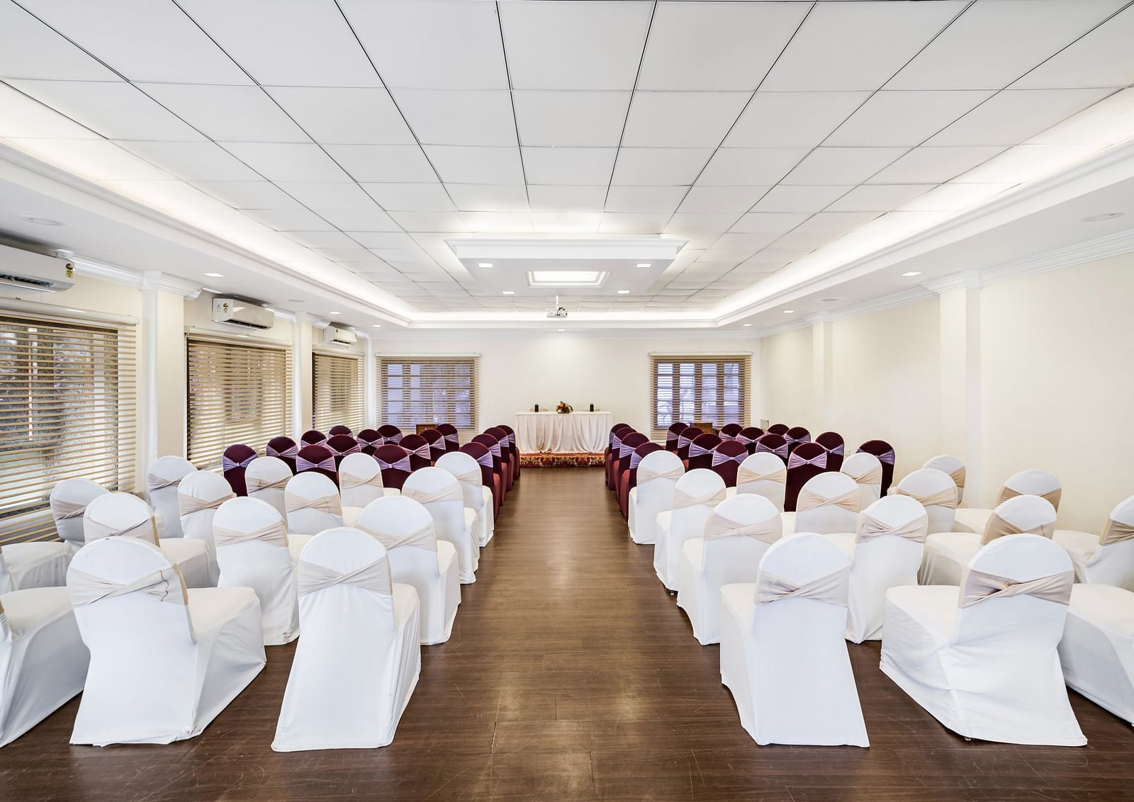 An image of a banquet hall with seating arrangement and bright lighting - GReaT Trails River View Resort Thanjavur By GRT Hotels