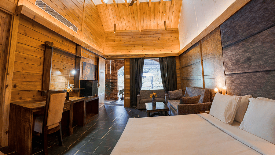 A view of the Master Suite with a large bed at the Sylvan Retreat, Dehradun.
