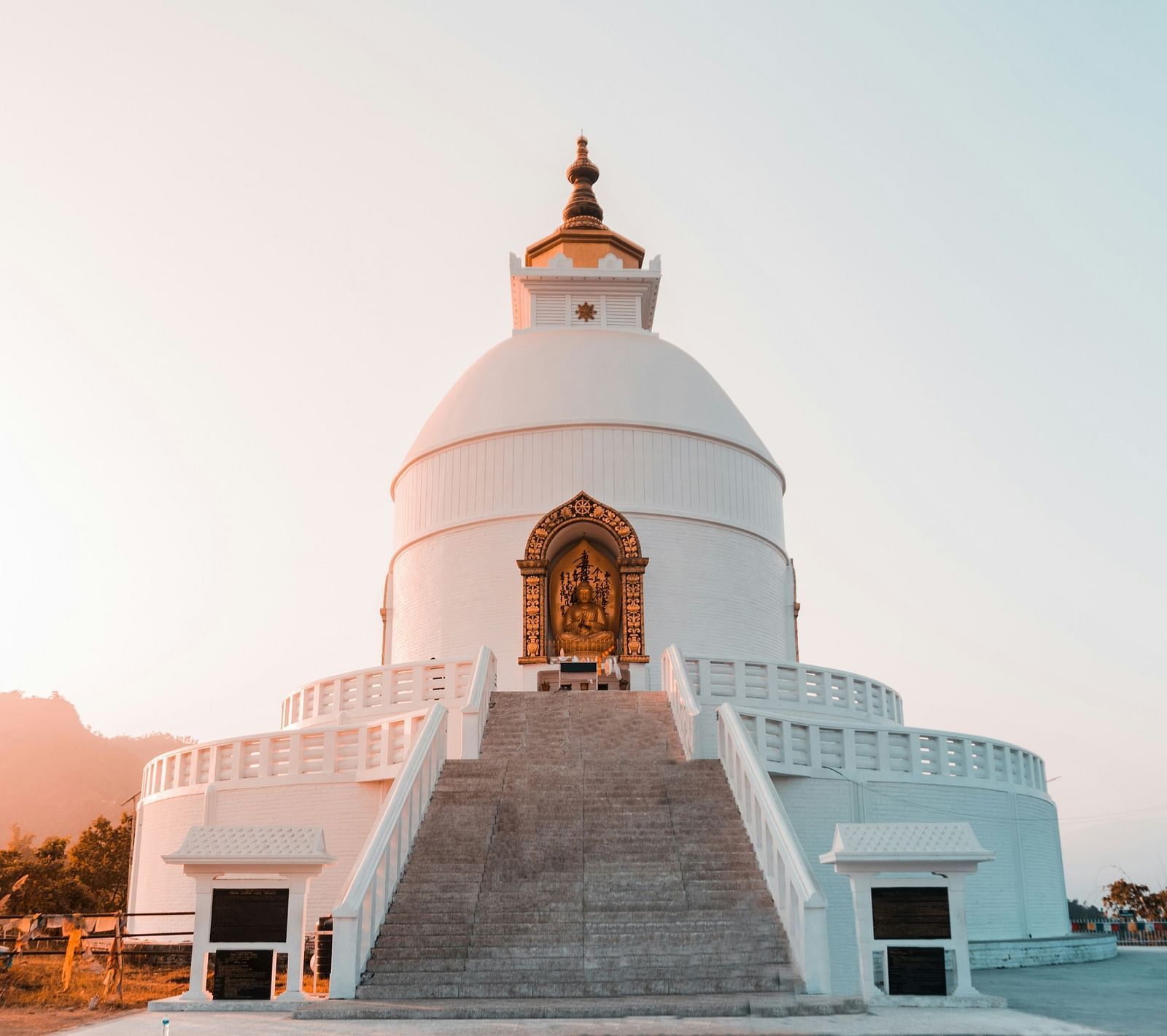 Facade image of World Peace Pagoda with the sun's rays hitting the side of the building.