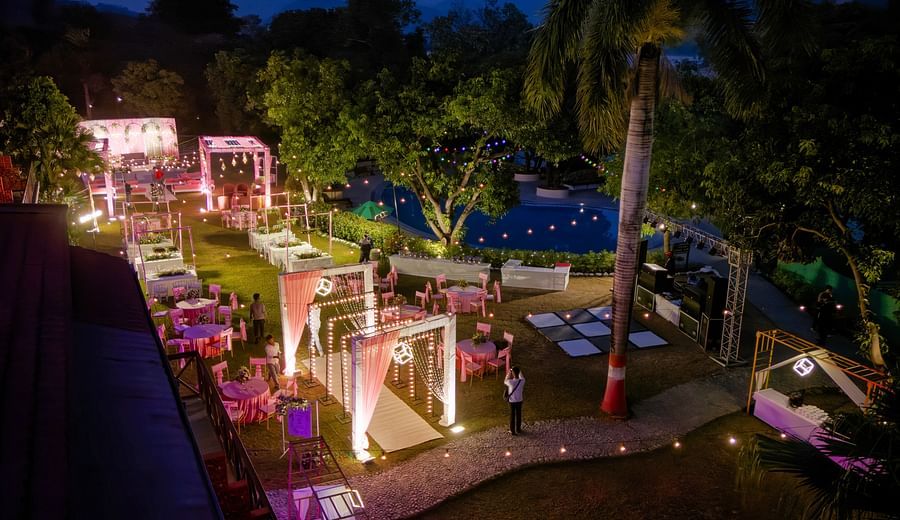 alt-text Bird's-eye view of a wedding reception with colorful lights.