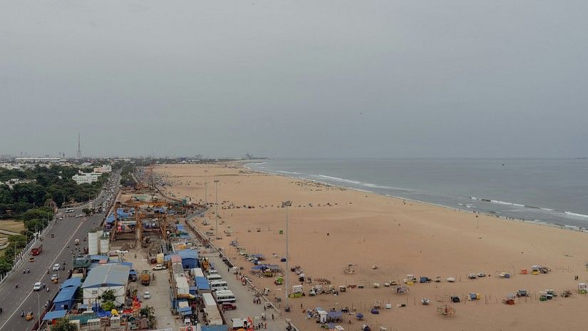 An aerial view of Marina Beach, Chennai, Tamil Nadu next to a road.