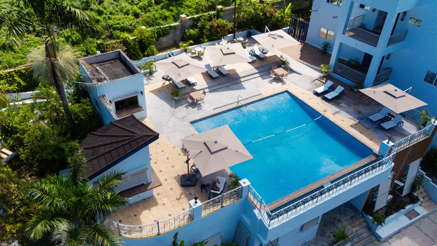 An aerial view of a rooftop pool surrounded by greenery on all sides of the Jamaica Hotel, Hotel 39 (Montego Bay)