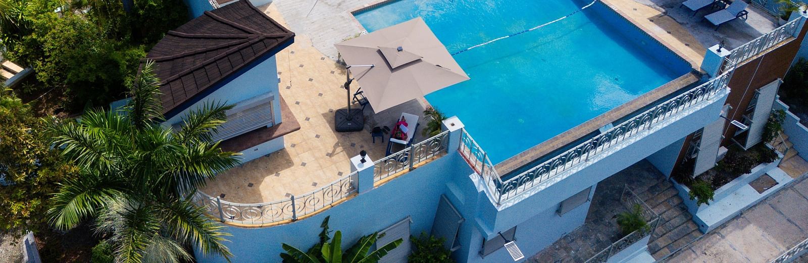 An aerial image of a rooftop pool surrounded by greenery on all sides - Hotel 39, Jamaica (Montego Bay)