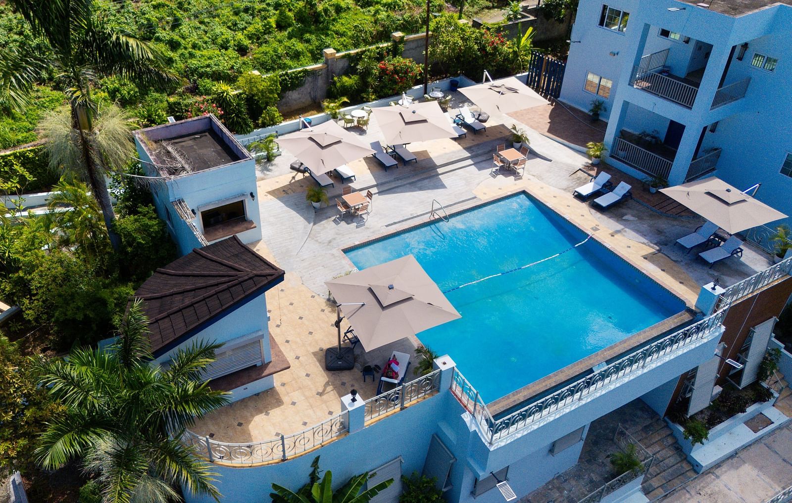An aerial image of a rooftop pool surrounded by greenery on all sides - Hotel 39, Jamaica (Montego Bay)