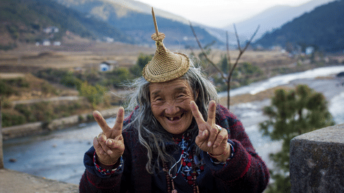 an old person showing the victory sign