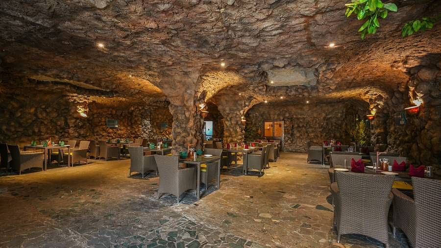 Kholong restaurant with a rock-themed décor, warm lighting, all tables, seating, and culinary arrangements arranged aesthetically3