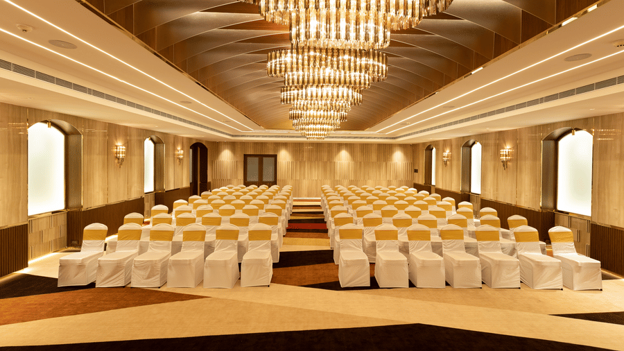 A grand venue featuring extensive theatre-style seating and decorative architectural ceilings - Jenneys Residency, Coimbatore