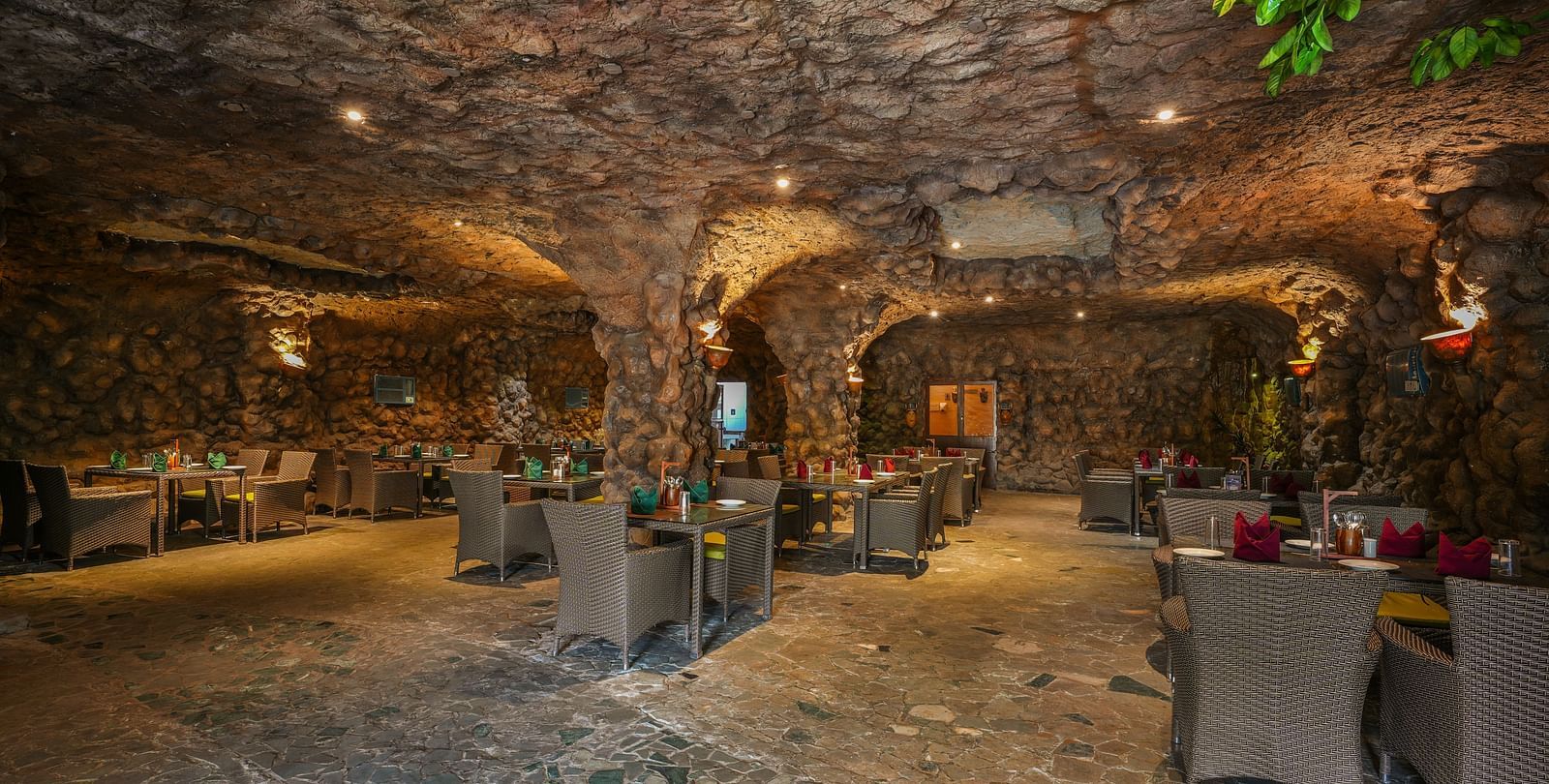 Kholong restaurant with a rock-themed décor, warm lighting, all tables, seating, and culinary arrangements arranged aesthetically3
