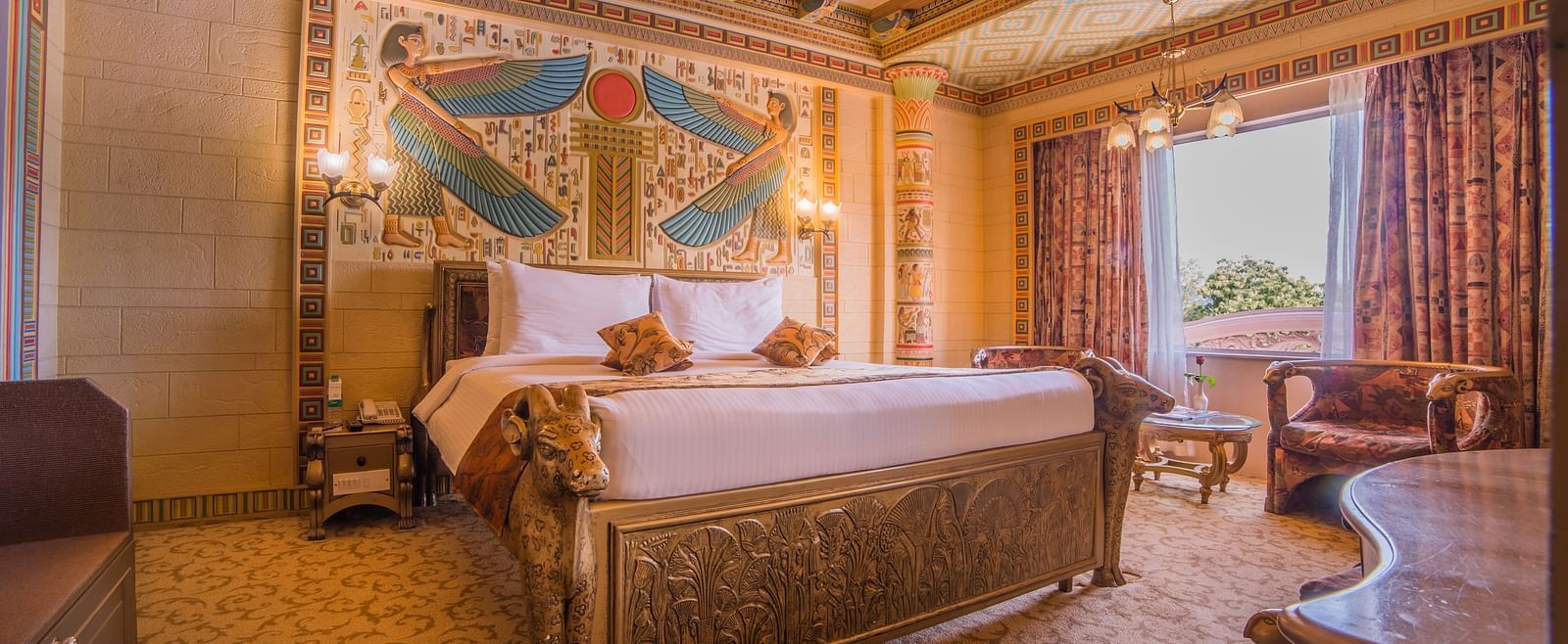 A lavish hotel room with golden decor and detailed wall designs, creating a royal ambiance at  Sitara Luxury Hotel in Hyderabad near Ramoji Film City.