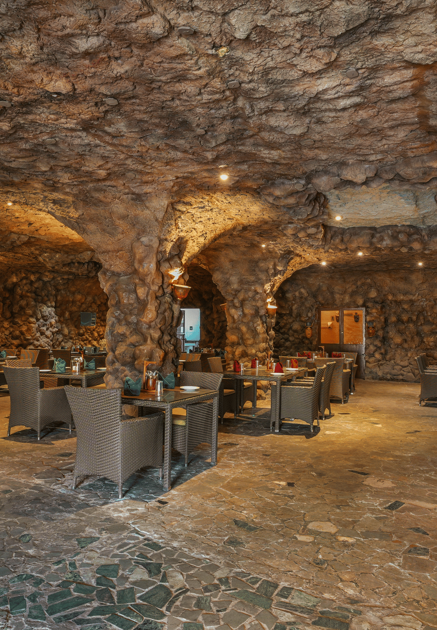 Kholong restaurant with a rock-themed décor, warm lighting, all tables, seating, and culinary arrangements arranged aesthetically3