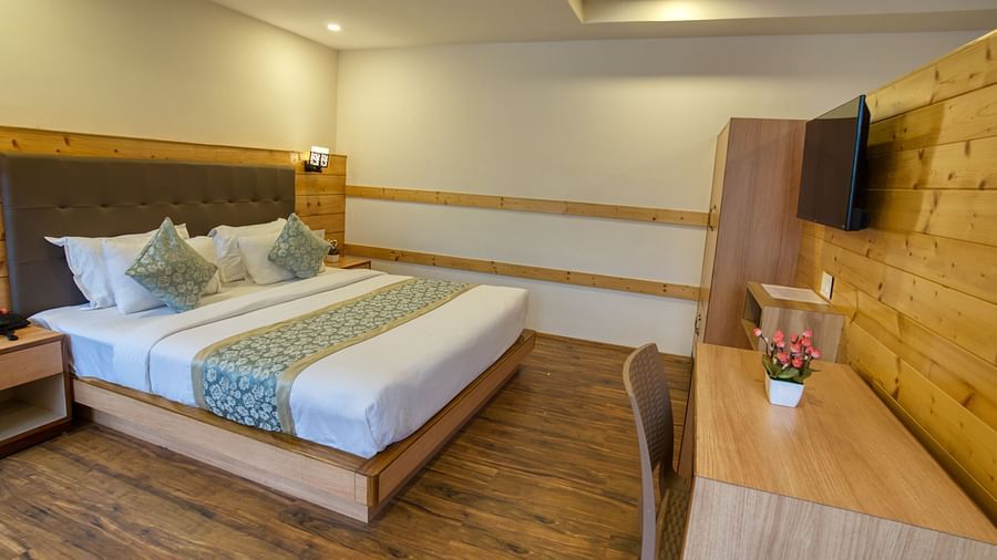 A image of the family suite with bed and TV in front I Avianna Gangtok Prime Hotel & Spa