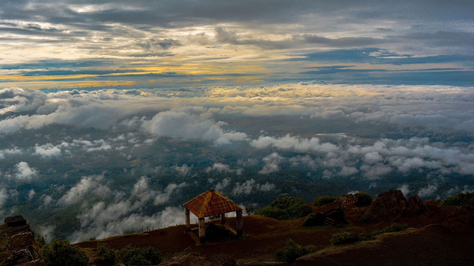 An overview of a viewpoint in the western ghats with many clouds in view.