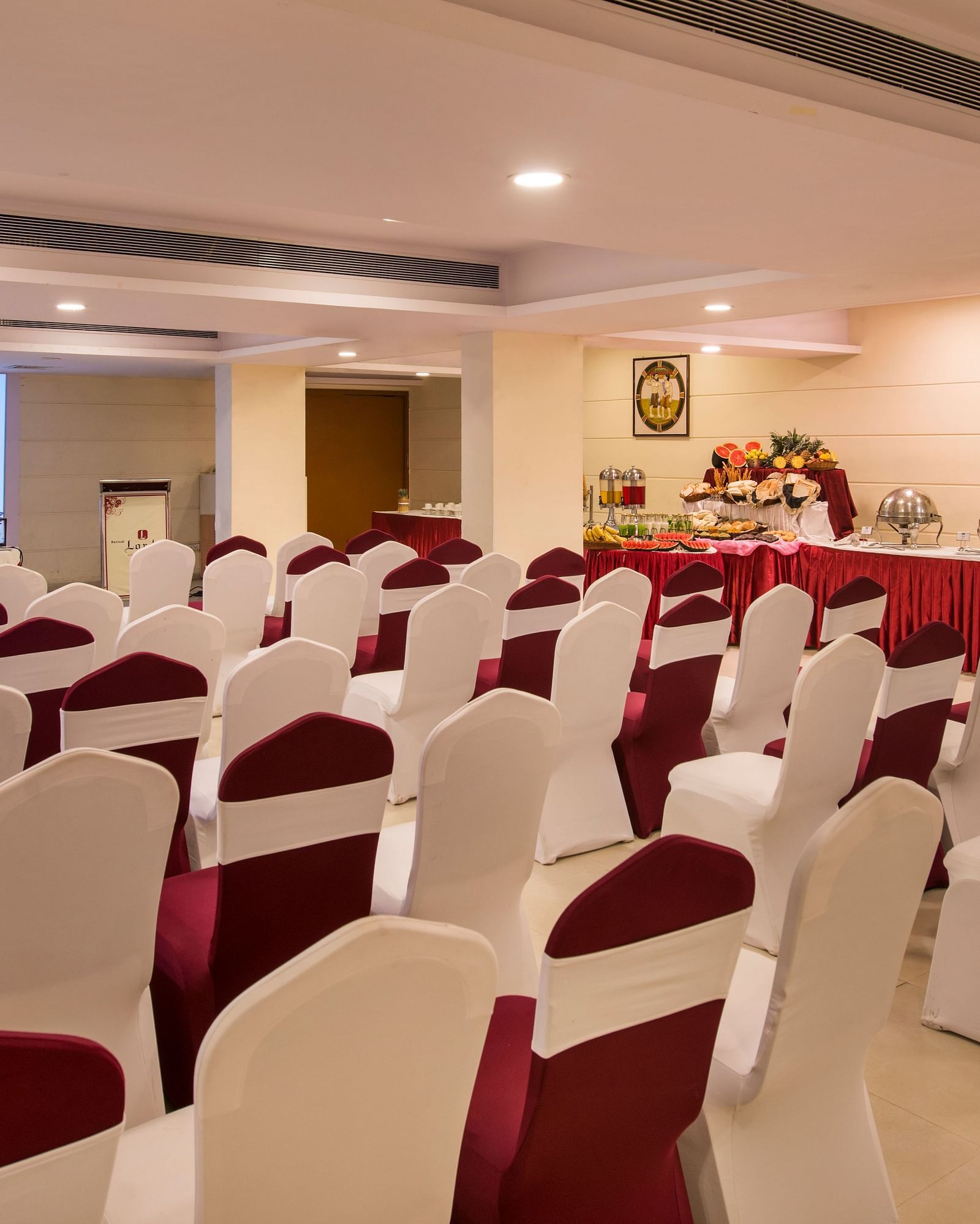 Another conference room shows rows of empty chairs facing a screen, ready for a presentation - Lords Inn Vadodara
