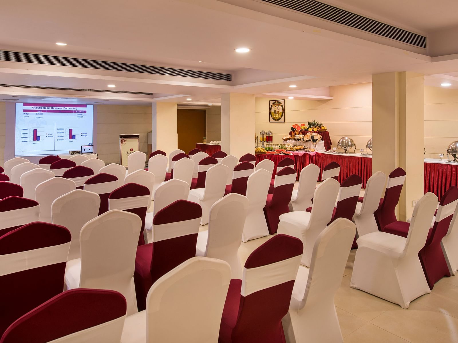 Another conference room shows rows of empty chairs facing a screen, ready for a presentation - Lords Inn Vadodara
