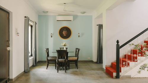 Elegant dining area with classic wooden furniture in the Three BHK Deluxe Villa at Richmonde Ananta Elite, Goa.