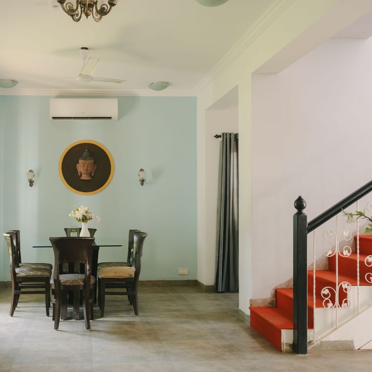 Elegant dining area with classic wooden furniture in the Three BHK Deluxe Villa at Richmonde Ananta Elite, Goa.
