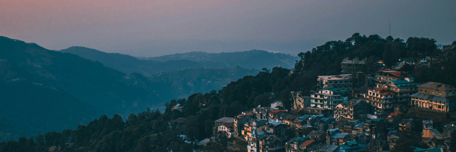 a hilly range on an evening with a beautiful sky with orange hues in the background in dalhousie - Dalhousie Places to Visit