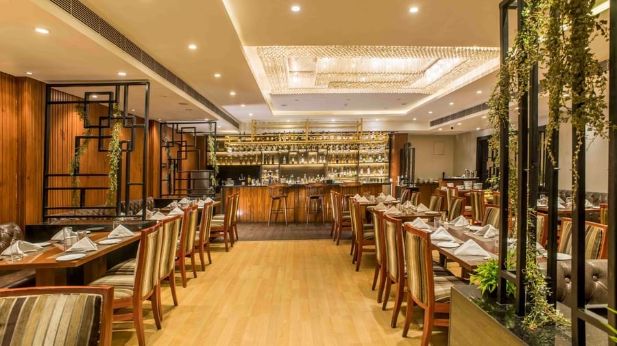 Elegant hotel restaurant with neatly arranged tables and chairs and subtle lighting | The Citi Residenci Hotel Durgapur
