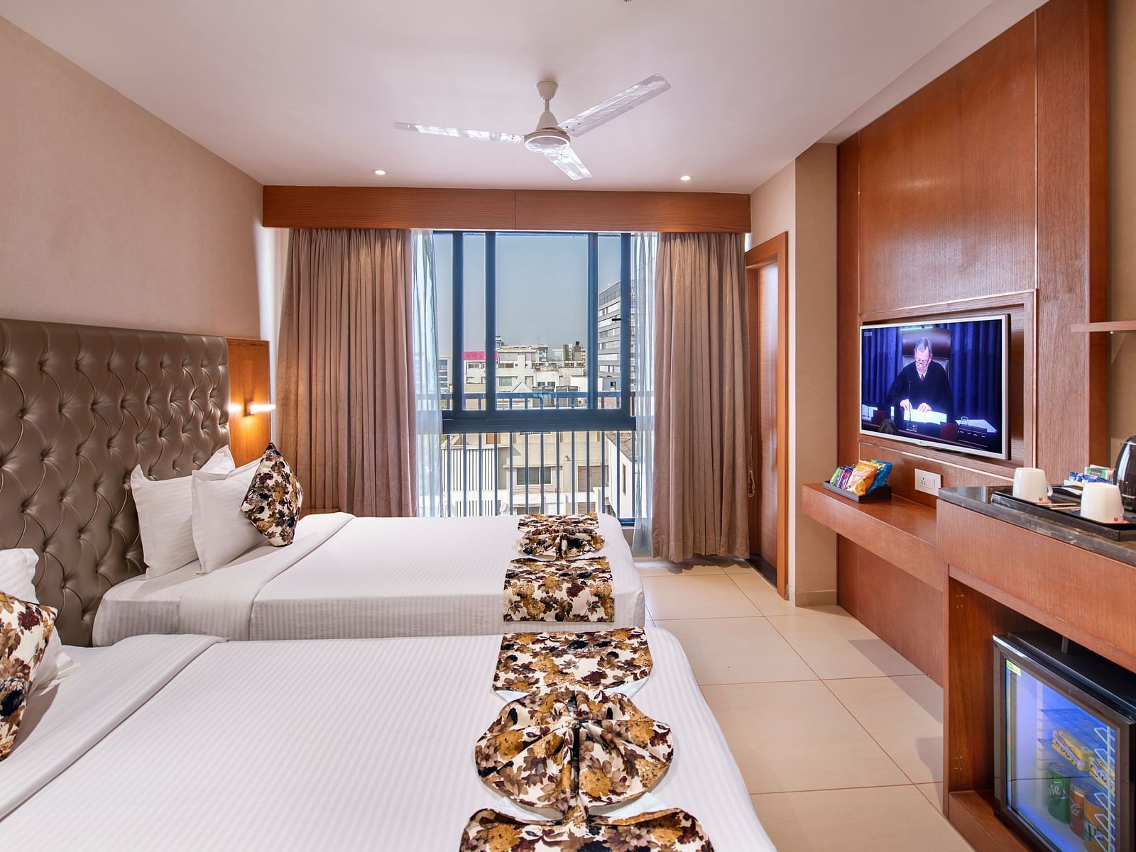 A comfortable hotel room with twin beds - SK Lords Inn Ahmedabad