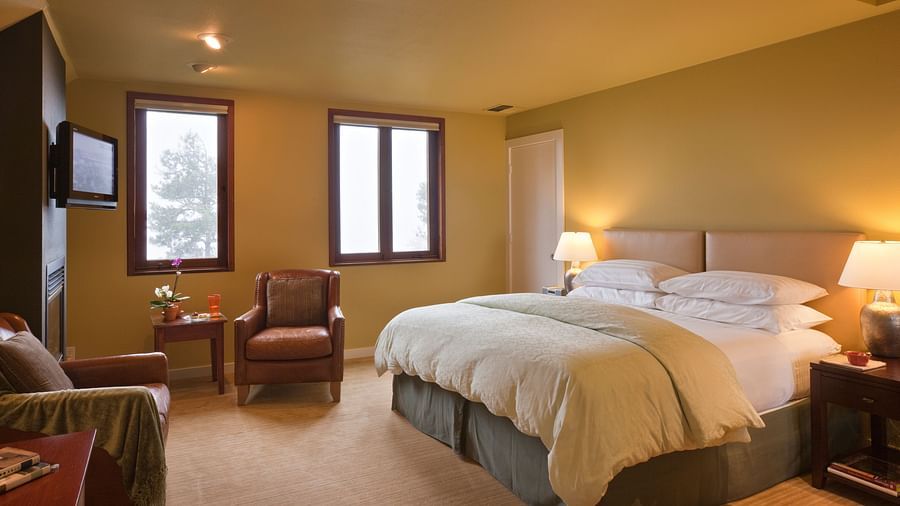 A cozy hotel room with soft lighting, comfortable furniture, and a relaxing ambiance, perfect for a restful stay - Brewery Gulch Inn & Spa