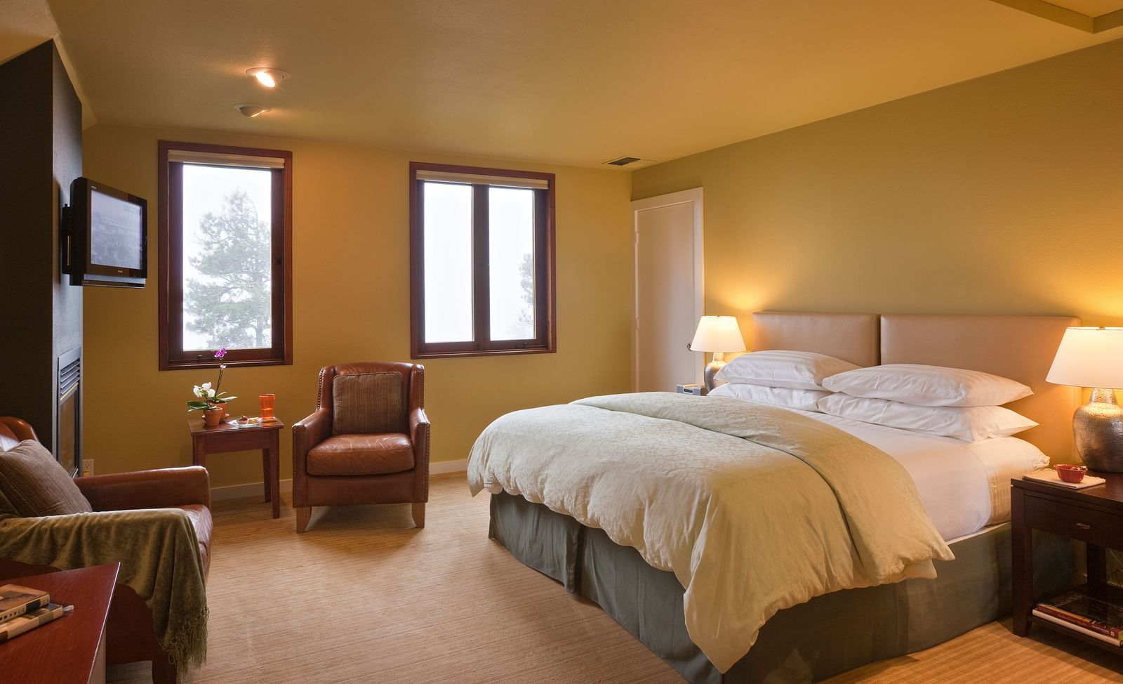 A cozy hotel room with soft lighting, comfortable furniture, and a relaxing ambiance, perfect for a restful stay - Brewery Gulch Inn & Spa