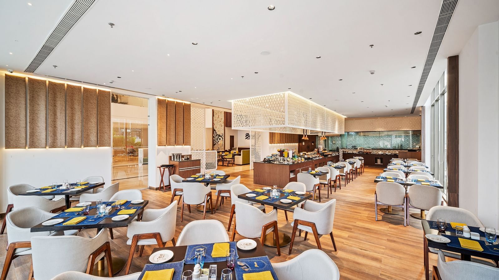 A dining setting at Grand Vijayawada Restaurant at Grand Vijayawada by GRT Hotels.